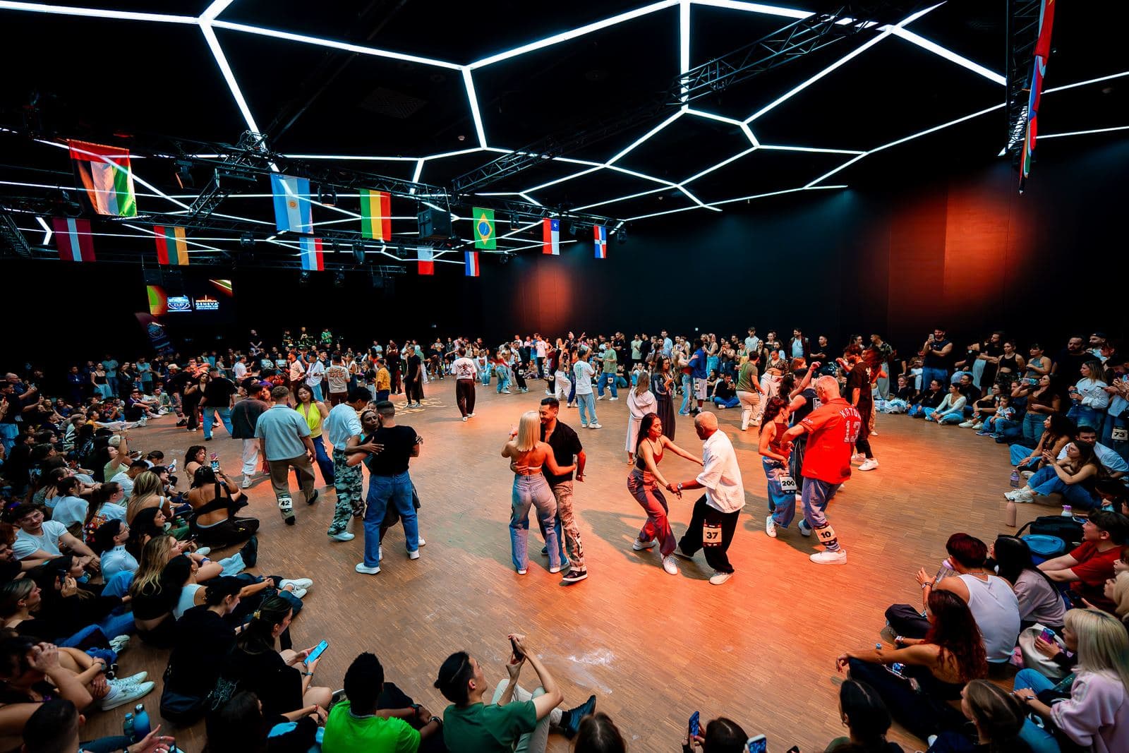 The competition floor under the hexagon ceiling and the flags