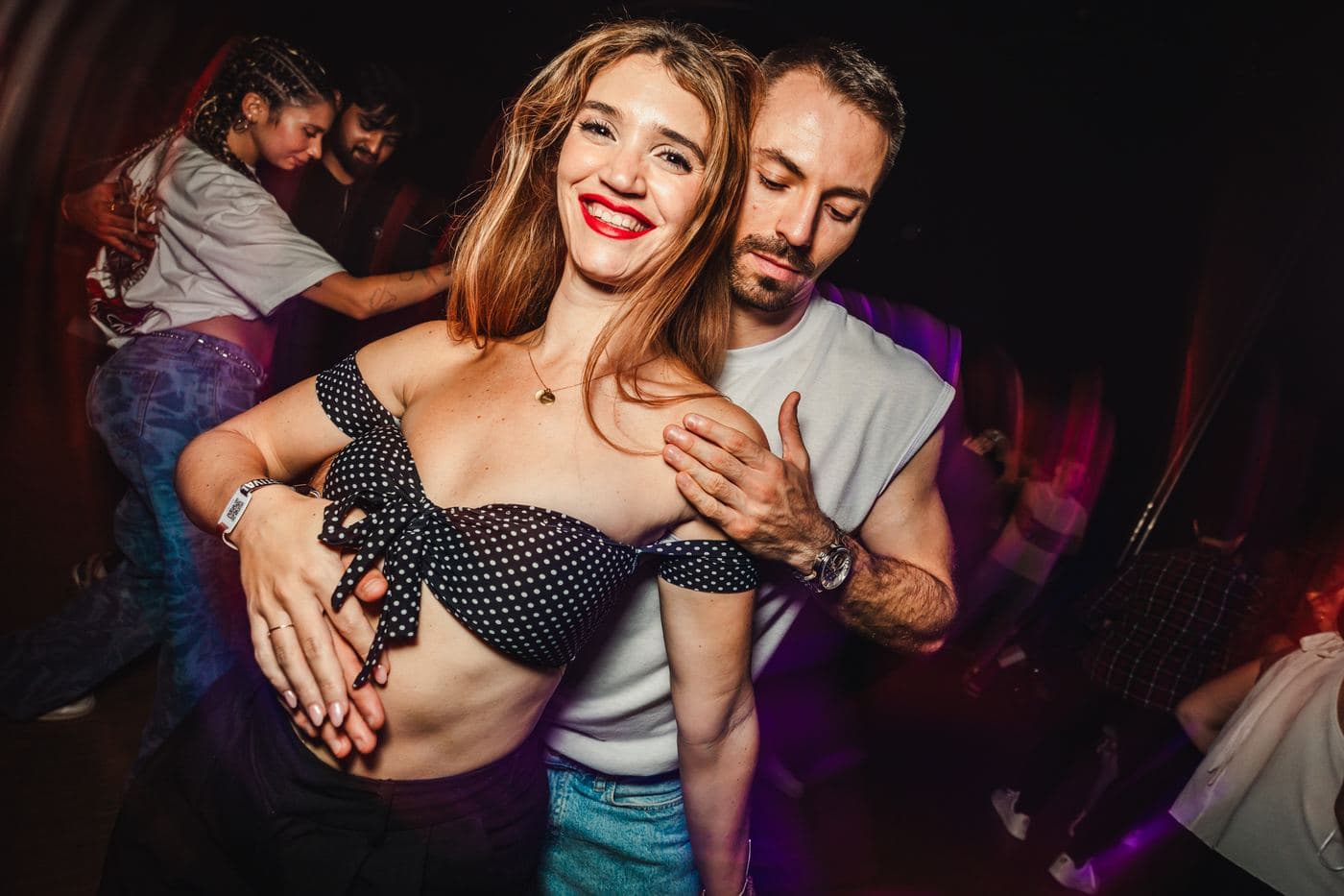 A couple smiling on the social dance floor